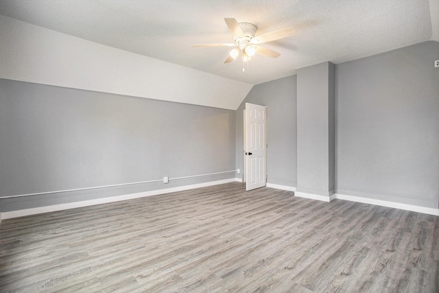 22121 Bedford Rd N, Battle Creek, MI 49017 - bonus room featuring ceiling fan, vaulted ceiling, wood finished floors, and a textured ceiling
