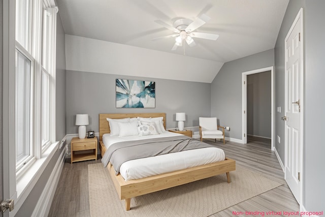 22121 Bedford Rd N, Battle Creek, MI 49017 - bedroom with wood finished floors, vaulted ceiling, and a ceiling fan