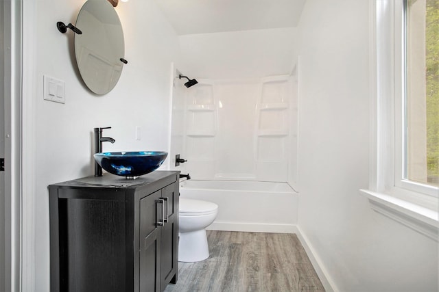 22121 Bedford Rd N, Battle Creek, MI 49017 - bathroom featuring wood finished floors, vanity, and bathing tub / shower combination