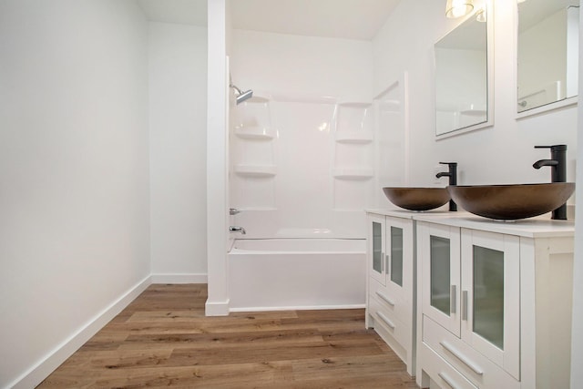 22121 Bedford Rd N, Battle Creek, MI 49017 - full bathroom featuring wood finished floors, shower / bath combination, and double vanity