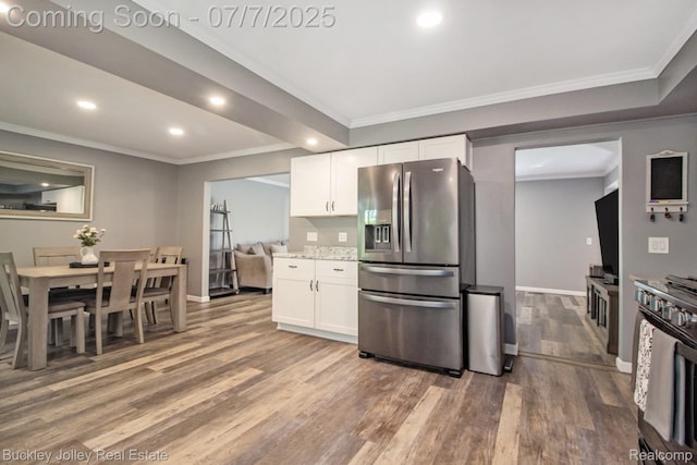 1049 Hillcrest Ave, Brighton, MI 48116 - kitchen featuring appliances with stainless steel finishes, recessed lighting, light wood-type flooring, white cabinets, and ornamental molding