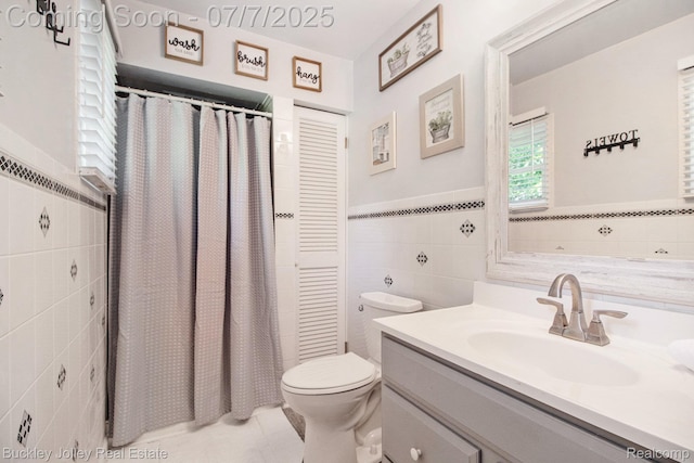 1049 Hillcrest Ave, Brighton, MI 48116 - full bathroom with tile walls, vanity, tile patterned flooring, wainscoting, and curtained shower