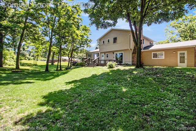 1049 Hillcrest Ave, Brighton, MI 48116 - view of grassy yard featuring a deck