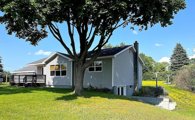 838 Meadow Dr, Traverse City, MI 49685 - view of side of property featuring a yard and a chimney