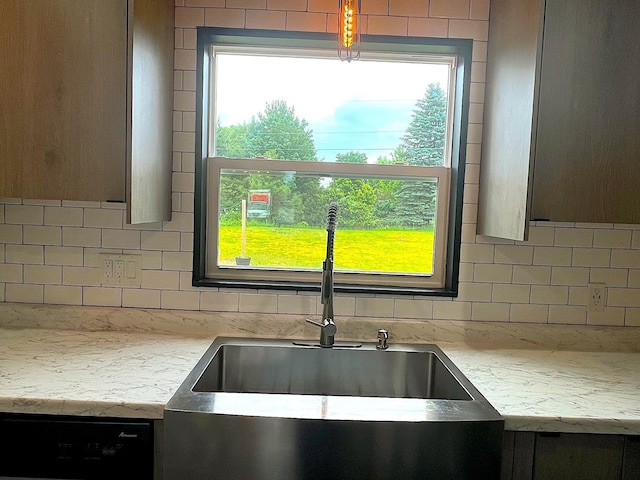 838 Meadow Dr, Traverse City, MI 49685 - kitchen with dishwashing machine, decorative backsplash, light countertops, and healthy amount of natural light