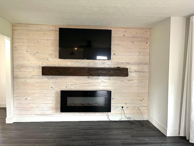 838 Meadow Dr, Traverse City, MI 49685 - detailed view of wood finished floors, a fireplace, and a textured ceiling