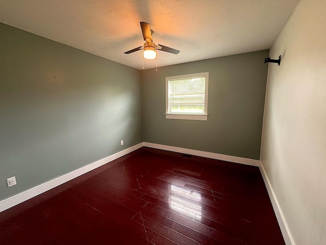 838 Meadow Dr, Traverse City, MI 49685 - empty room with dark wood-style flooring, ceiling fan, and a textured ceiling