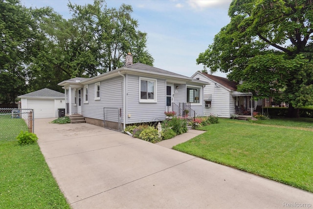 14634 Mcguire St, Taylor, MI 48180 - view of front of house with an outbuilding, a chimney, a detached garage, and concrete driveway