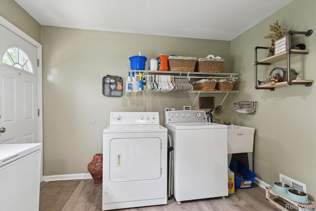 14634 Mcguire St, Taylor, MI 48180 - laundry area featuring washer and clothes dryer and wood finished floors
