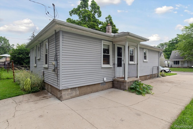 14634 Mcguire St, Taylor, MI 48180 - view of front facade featuring a chimney, crawl space, and a patio area