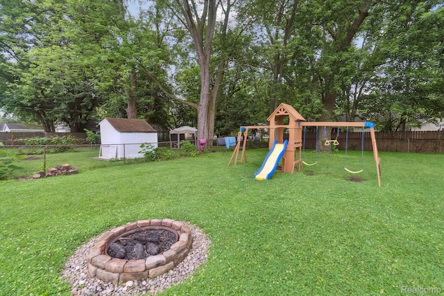 14634 Mcguire St, Taylor, MI 48180 - fenced backyard featuring a playground and a fire pit