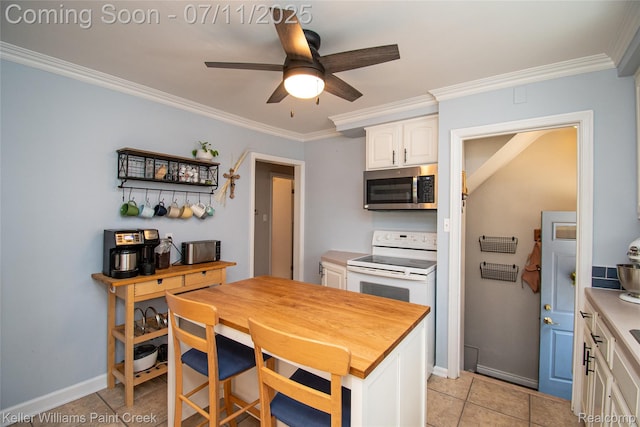 1968 Oxford Rd, Grosse Pointe Woods, MI 48236 - kitchen featuring stainless steel microwave, white electric range oven, white cabinetry, ornamental molding, and ceiling fan