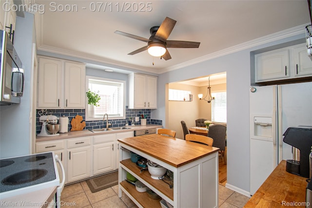 1968 Oxford Rd, Grosse Pointe Woods, MI 48236 - kitchen featuring butcher block countertops, white appliances, decorative backsplash, white cabinets, and light tile patterned flooring