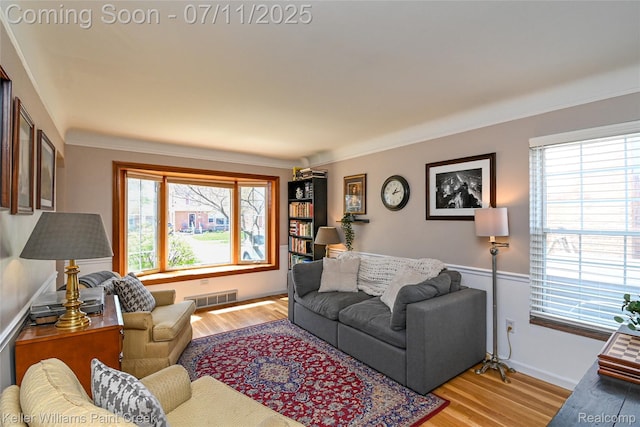 1968 Oxford Rd, Grosse Pointe Woods, MI 48236 - living area with plenty of natural light, light wood finished floors, and ornamental molding