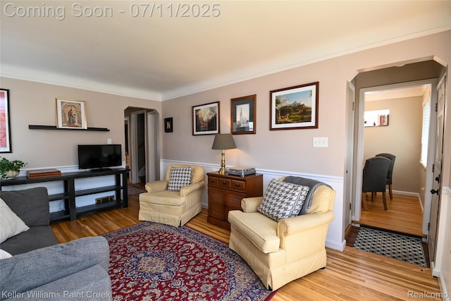 1968 Oxford Rd, Grosse Pointe Woods, MI 48236 - living area with arched walkways, light wood finished floors, and ornamental molding