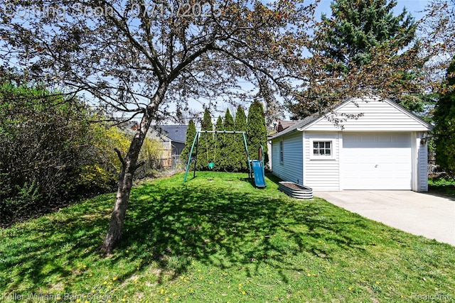 1968 Oxford Rd, Grosse Pointe Woods, MI 48236 - view of yard featuring a playground, a garage, an outdoor structure, and driveway