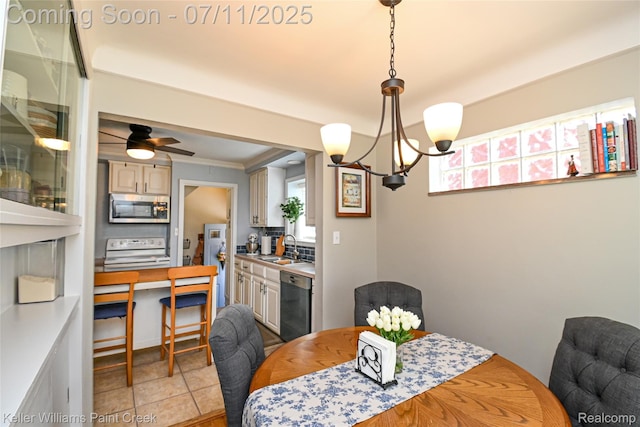 1968 Oxford Rd, Grosse Pointe Woods, MI 48236 - dining room with a chandelier, ornamental molding, and light tile patterned flooring