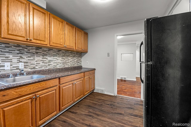 808 Pagel Ave, Lincoln Park, MI 48146 - kitchen with freestanding refrigerator, dark wood finished floors, backsplash, dark countertops, and brown cabinets