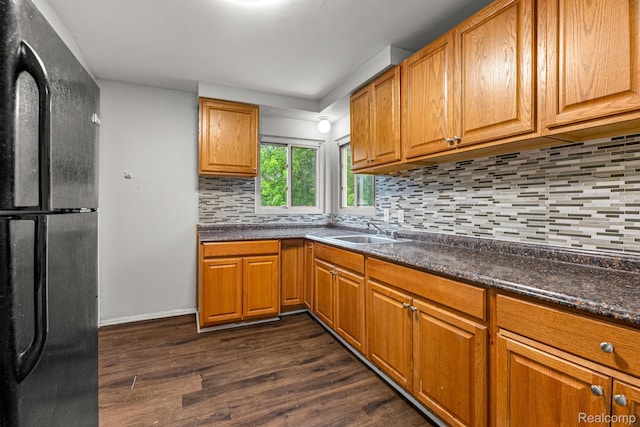 808 Pagel Ave, Lincoln Park, MI 48146 - kitchen with freestanding refrigerator, dark wood-style flooring, dark countertops, backsplash, and brown cabinetry