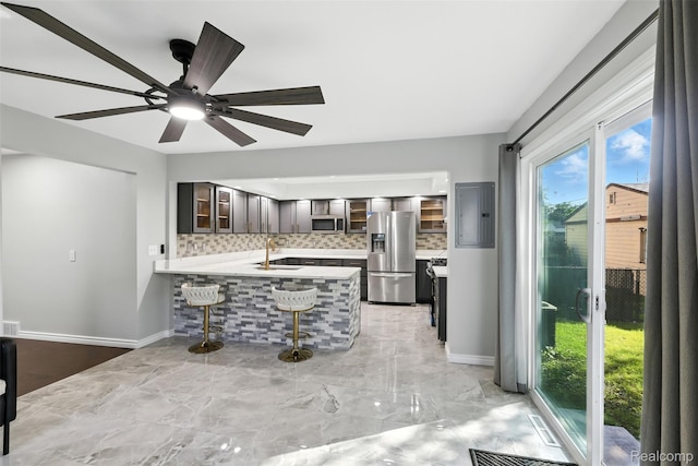 17652 Robert St, Melvindale, MI 48122 - kitchen with stainless steel appliances, electric panel, light countertops, tasteful backsplash, and glass insert cabinets