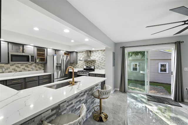 17652 Robert St, Melvindale, MI 48122 - kitchen featuring appliances with stainless steel finishes, wall chimney exhaust hood, tasteful backsplash, light marble finish floors, and light stone counters