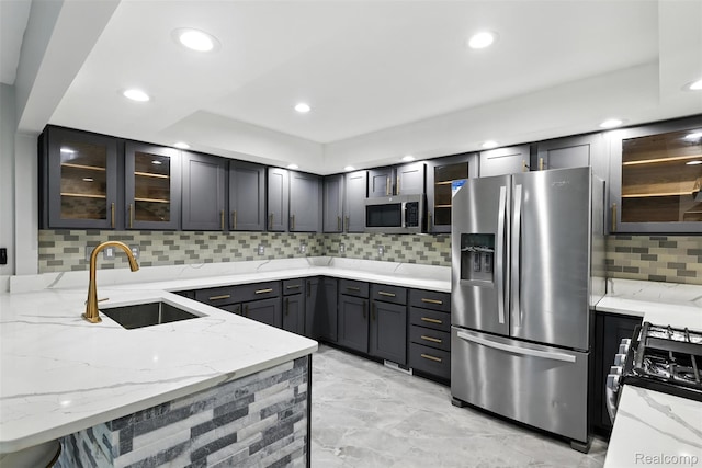 17652 Robert St, Melvindale, MI 48122 - kitchen with stainless steel appliances, backsplash, light stone countertops, recessed lighting, and glass insert cabinets