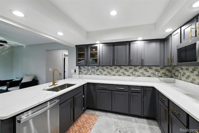 17652 Robert St, Melvindale, MI 48122 - kitchen featuring appliances with stainless steel finishes, recessed lighting, a peninsula, backsplash, and light stone counters
