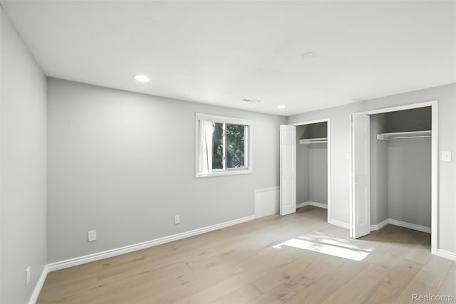 17652 Robert St, Melvindale, MI 48122 - unfurnished bedroom with two closets, wood finished floors, and recessed lighting