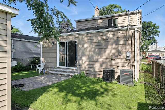 17652 Robert St, Melvindale, MI 48122 - back of property with entry steps, a chimney, and a patio