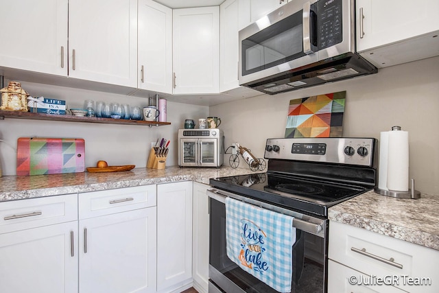 11986 Reyburn Dr NE, Sparta, MI 49345 - kitchen featuring appliances with stainless steel finishes, white cabinetry, light countertops, and open shelves