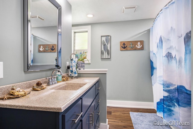 11986 Reyburn Dr NE, Sparta, MI 49345 - bathroom with vanity and wood finished floors