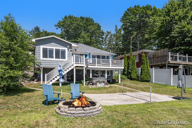 11986 Reyburn Dr NE, Sparta, MI 49345 - rear view of house featuring a fire pit, a hot tub, stairs, a wooden deck, and a patio