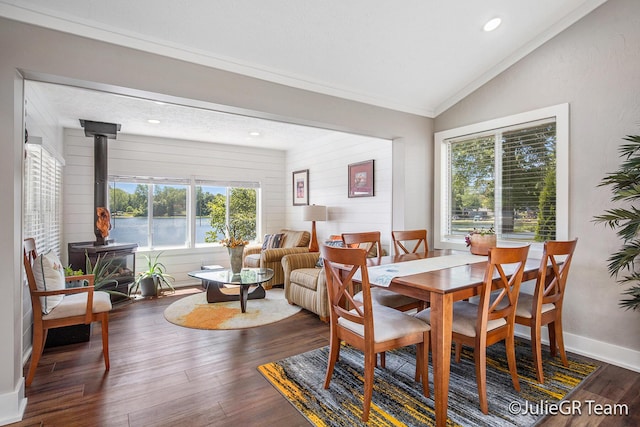 11986 Reyburn Dr NE, Sparta, MI 49345 - dining space with a wood stove, lofted ceiling, wood finished floors, recessed lighting, and ornamental molding