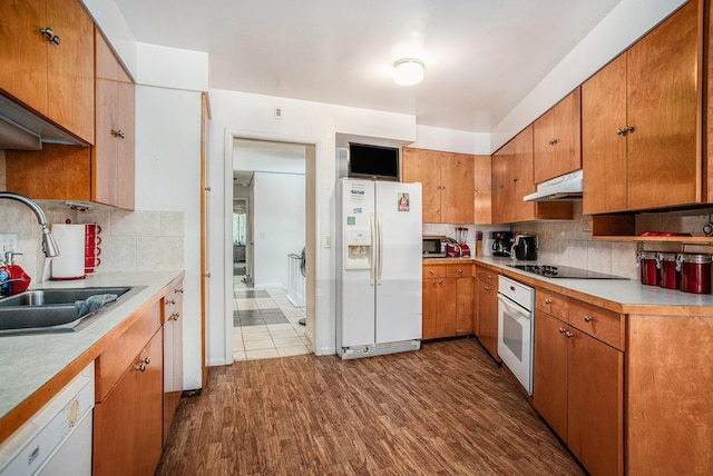 3706 Northview Dr, Kalamazoo, MI 49004 - kitchen featuring white appliances, under cabinet range hood, light countertops, backsplash, and dark wood-style flooring