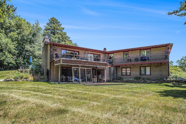 3706 Northview Dr, Kalamazoo, MI 49004 - back of house with a lawn, brick siding, a chimney, and a wooden deck