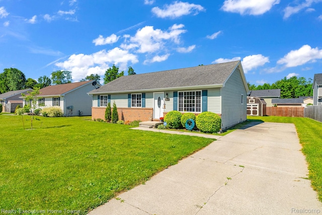 4217 Tristen Ave, Fort Gratiot, MI 48059 - single story home with a shed, concrete driveway, a shingled roof, and brick siding