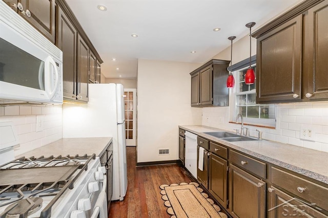 2220 Mershon St, Saginaw, MI 48602 - kitchen with white appliances, dark brown cabinets, dark wood finished floors, decorative backsplash, and recessed lighting