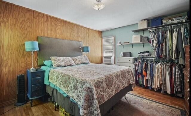 519 Hanover St, Concord, MI 49237 - bedroom with wood walls, wood finished floors, and a closet
