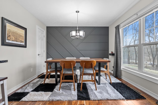 5643 E C Ave, Richland, MI 49083 - dining room featuring plenty of natural light, a chandelier, wood finished floors, a decorative wall, and an accent wall