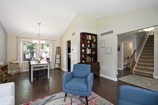 7981 Faircrest Dr, Ypsilanti, MI 48197 - living room with stairway, dark wood finished floors, a chandelier, and high vaulted ceiling