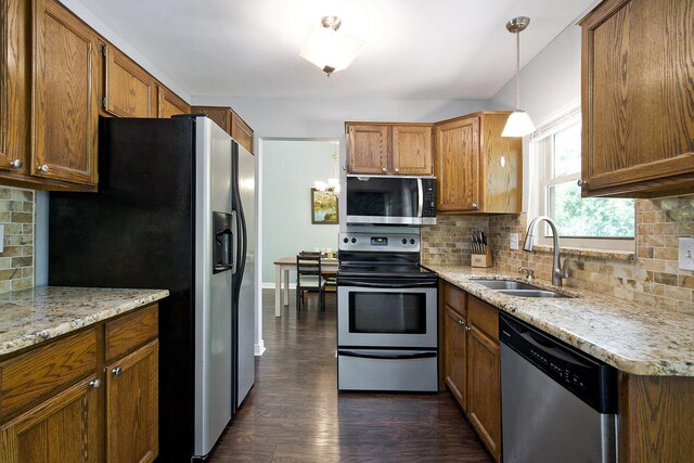 7981 Faircrest Dr, Ypsilanti, MI 48197 - kitchen featuring appliances with stainless steel finishes, tasteful backsplash, dark wood-type flooring, and brown cabinetry