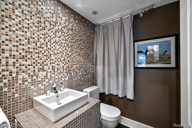 504 Landon St, Birmingham, MI 48009 - bathroom featuring toilet and tile walls