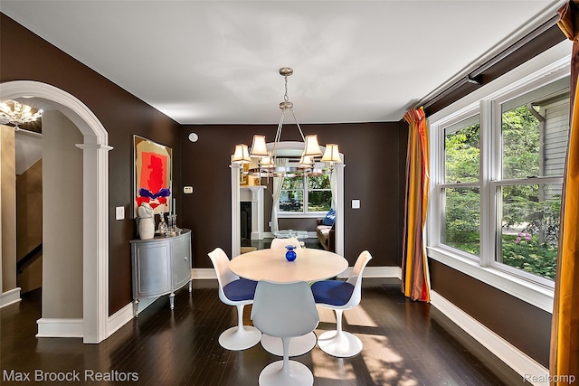 504 Landon St, Birmingham, MI 48009 - dining room featuring a chandelier, dark wood-style floors, and arched walkways