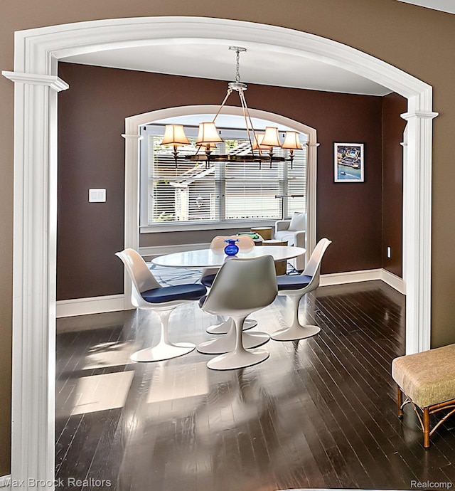 504 Landon St, Birmingham, MI 48009 - dining room with a chandelier, wood finished floors, and arched walkways