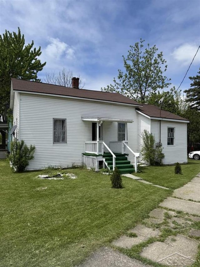 1541 Emily St, Saginaw, MI 48601 - view of front of home with a chimney and a front lawn