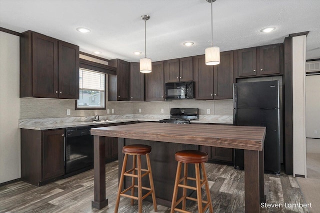 947 Redwood Dr, Hastings, MI 49058 - kitchen with black appliances, dark brown cabinetry, butcher block counters, dark wood-type flooring, and recessed lighting
