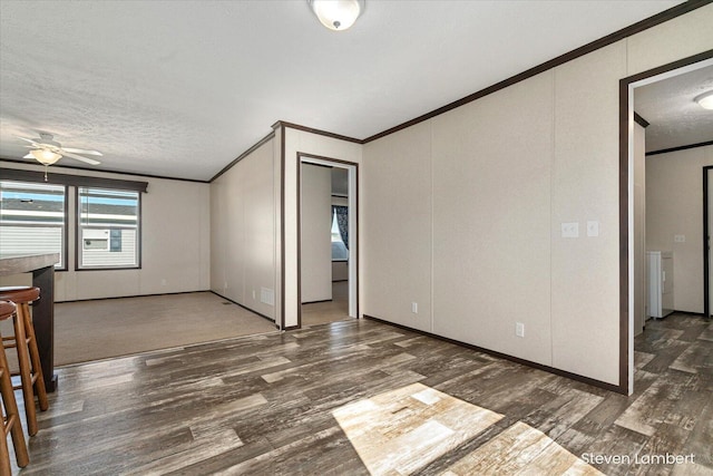 947 Redwood Dr, Hastings, MI 49058 - unfurnished room featuring crown molding, wood finished floors, a textured ceiling, a ceiling fan, and a decorative wall