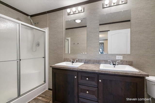 947 Redwood Dr, Hastings, MI 49058 - bathroom featuring a shower stall, double vanity, and wood finished floors