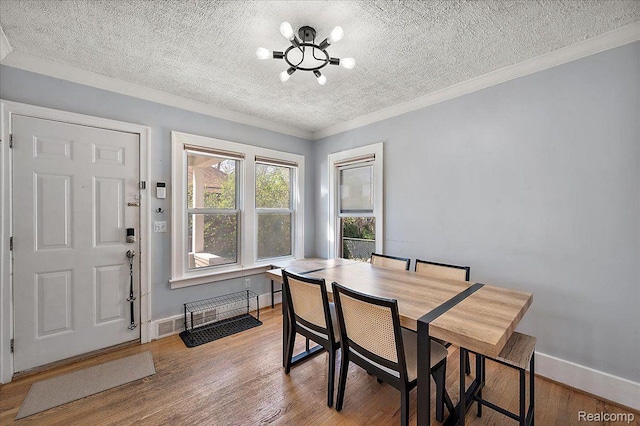 129 E Maryland Ave, Royal Oak, MI 48067 - dining room with a chandelier, a textured ceiling, ornamental molding, and wood finished floors