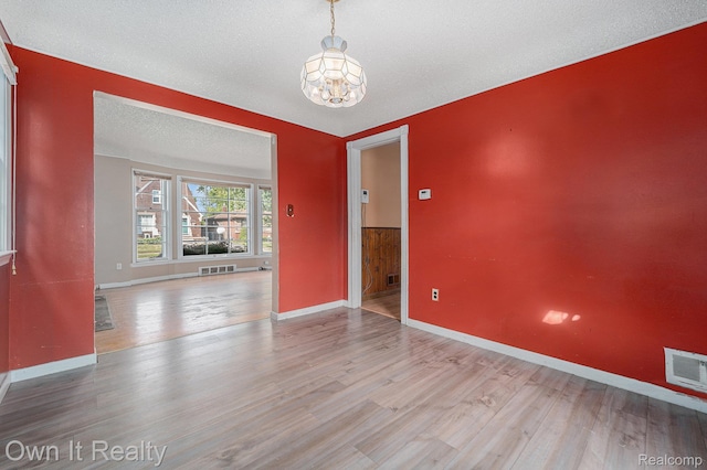 74 Chestnut St, River Rouge, MI 48218 - empty room with a chandelier, wood finished floors, and a textured ceiling